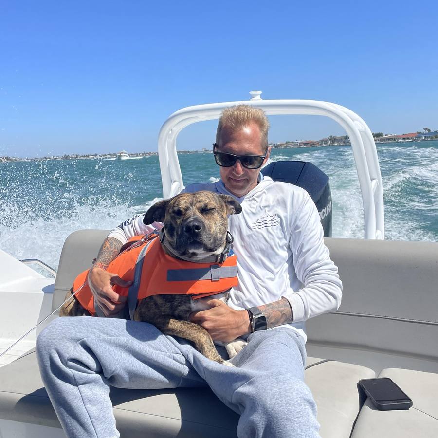 Jim Sanders with his dog Merlin on the boat